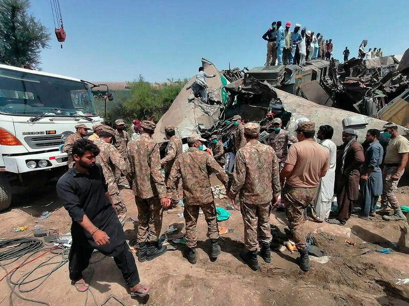 A photo from the Pakistan Army's Inter Services Public Relations media wing shows troops and rescue workers at the site in Ghotki, southern Pakistan, where more than 30 people were killed in a train crash on Monday. Rescuers worked to pull survivors and bodies from the wreckage. AP Photo