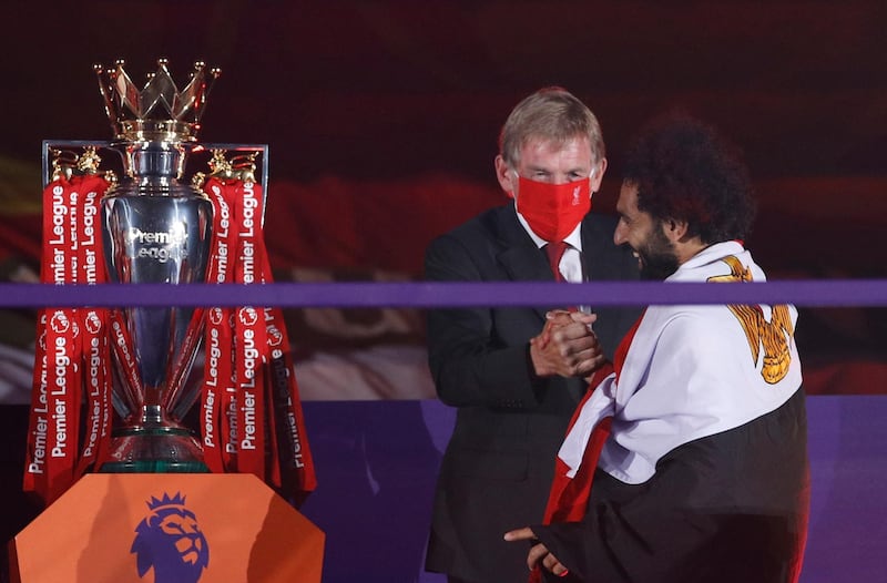 Kenny Dalglish with Liverpool's Mohamed Salah on the podium after winning the Premier League. Reuters