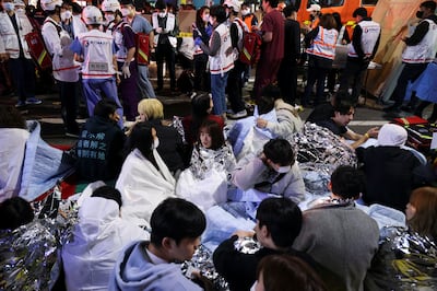 People sit on the street after being helped by medical workers. Reuters.