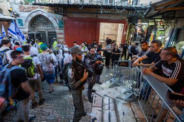 Israeli border and riot police separate Palestinians from thousands of marching Israelis who pass through the Muslim Quarter of Jerusalem's Old City. EPA