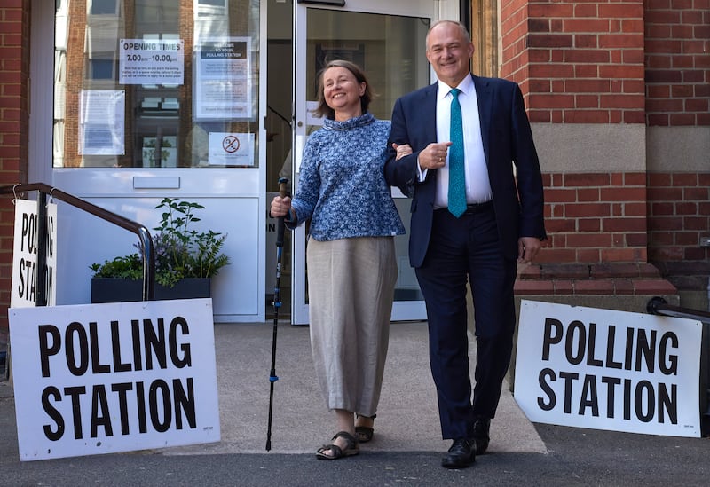 Leader of the Liberal Democrats Ed Davey and his wife Emily Gasson leave the polling station in Surbiton. Getty Images