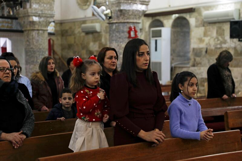 An Iraqi Christian family attends Mass in Al Hamdaniya. Reuters