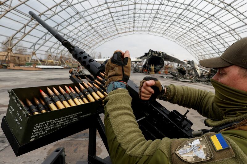 A member of the mobile air defence group checks an M2 Browning machine gun atop of a pick-up truck in the town of Hostomel, Ukraine. Reuters