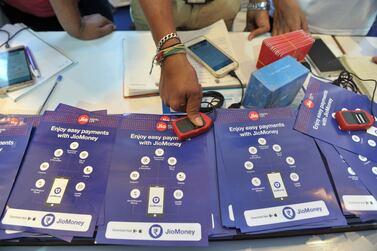 An Indian visitor gives a thumb impression to withdraw money from a Jio Easy Money outlet with his Unique Identification card. India's digital sector is accelerating faster than ever as Covid-19 forces businesses and customers online. AFP