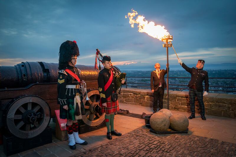 A platinum jubilee beacon is lit by Lord Provost Robert Aldridge and Commander of Edinburgh Garrison Lieutenant Colonel Lorne Campbell at Edinburgh Castle, Scotland, Thursday June 2, 2022, on day one of Queen Elizabeth II's platinum jubilee celebrations. PA