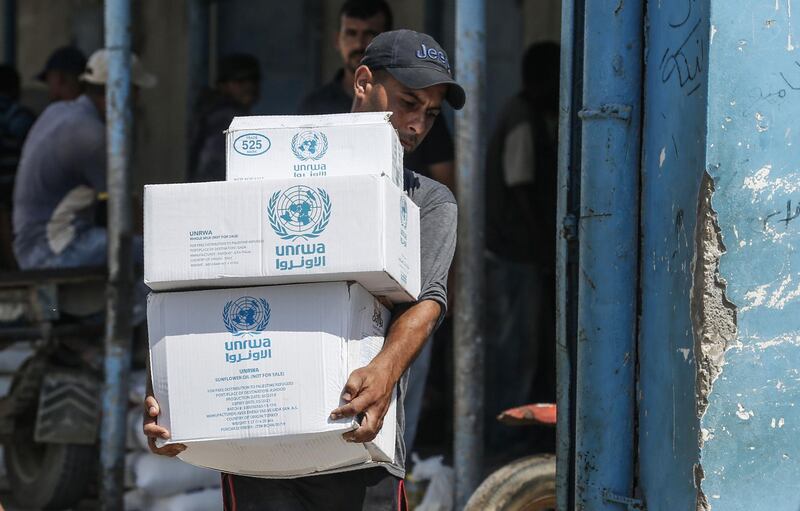 A Palestinian man transports boxes of food outside an aid distribution centre run by the United Nations Relief and Works Agency (UNRWA) in the central Gaza Strip refugee camp of Bureij, on July 31, 2019.  An internal ethics report has alleged mismanagement and abuses of authority at the highest levels of the UN agency for Palestinian refugees even as the organisation faced an unprecedented crisis after US funding cuts.
Lacking natural resources, the Gaza Strip suffers from a chronic shortage of water, electricity and petrol. More than two-thirds of the population depends on humanitarian aid.
 / AFP / SAID KHATIB
