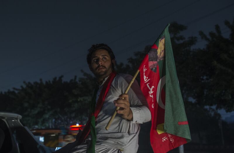 A supporter of Mr Khan's Pakistan Tehreek-e-Insaf party takes part in a protest in Lahore. Bloomberg