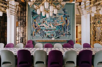 The grand, mirrored dining room doubled as a board room for important meetings. A hand-woven mergoum with a fishing scene covers one wall. Erin Clare Brown / The National