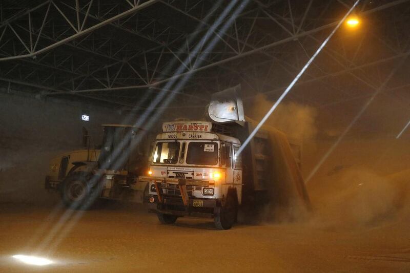A truck is being loaded with wheat inside a warehouse at Mundra Port. Amit Dave / Reuters
