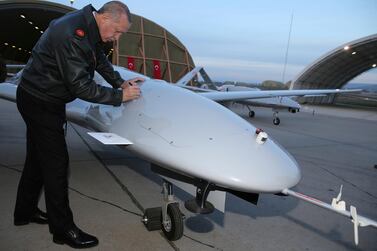 President Recep Tayyip Erdogan signs a Turkish drone at a military airbase in south-east Turkey, in 2018. AP