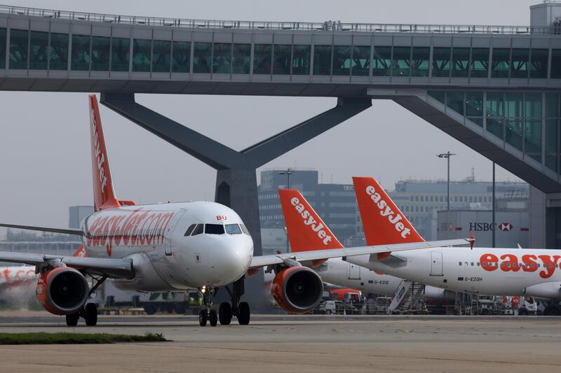 A passenger aircraft operated by EasyJet Plc taxis past other aircraft at London Gatwick airport in Crawley, U.K., on Wednesday, Sept. 27, 2017. EasyJet��revealed that it's working with U.S. startup��Wright Electric to develop a battery-powered plane.��Photographer: Luke MacGregor/Bloomberg