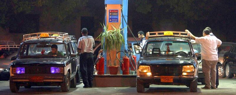 Taxi drivers fill up their vehicles at a gas station in Cairo. Amr Dalsh / Reuters