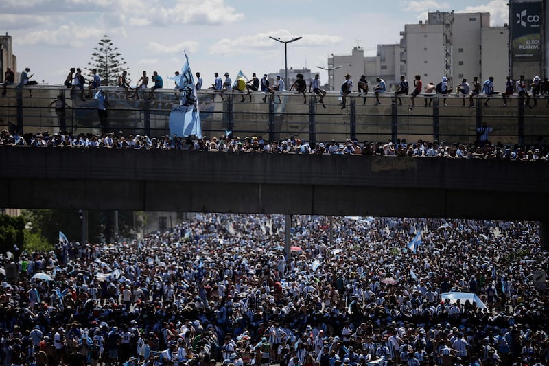 Fans of Argentina await the arrival of the team's bus. AFP