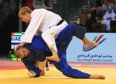 ABU DHABI - UNITED ARAB EMIRATES - 02OCT2014 - UAE's  Ivan Remarenco (in white) and Belgium's Toma Nikiforov fights in quarter- final in -100 kilograms category during Judo Grand Slam, Abu Dhabi 2014, organised International Judo Federation yesterday at FGB Arena at the Zayed Sports City in Abu Dhabi. Ravindranath K / The National (to go with Amith story for Sports)