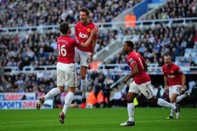 Jonny Evans, centre, celebrates after scoring the first goal against Newcastle United. Stu Forster / Getty Images