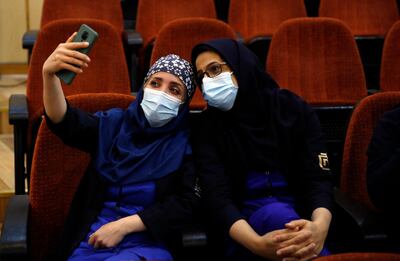 epa08998250 Iranian health workers take selfie before getting Sputnik V Covid-19 vaccine during a ceremony at the Imam Khomeini hospital in Tehran, Iran, 09 February 2021. Iran started its COVID-19 vaccination after receiving the first package of Russian Sputnik V vaccine.  EPA/ABEDIN TAHERKENAREH