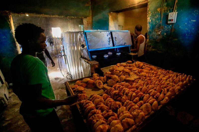Sudanese people buy bread at a bakery in the town of Atbara, an industrial town 350 kilometres northeast of Sudan’s capital Khartoum.  AFP