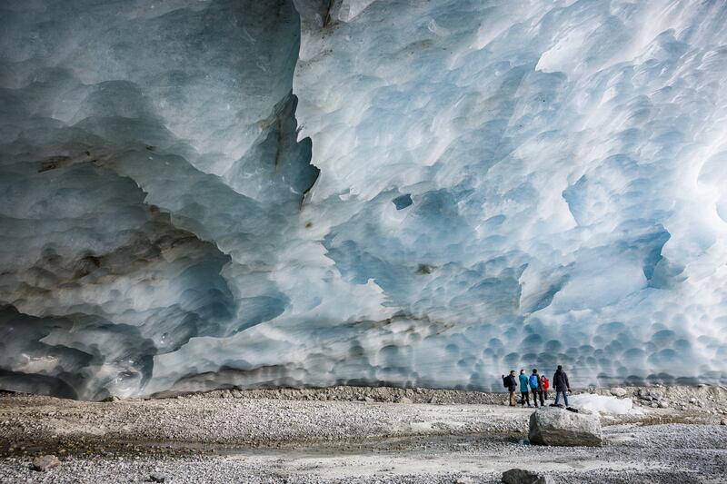 Hikers visit an ice cave formed at the end section of the Zinal glacier, above the alpine village of Zinal, Switzerland, on November 13. Over the past 60 years the overall glacier volume in Switzerland has shrunk by almost 50 percent. EPA
