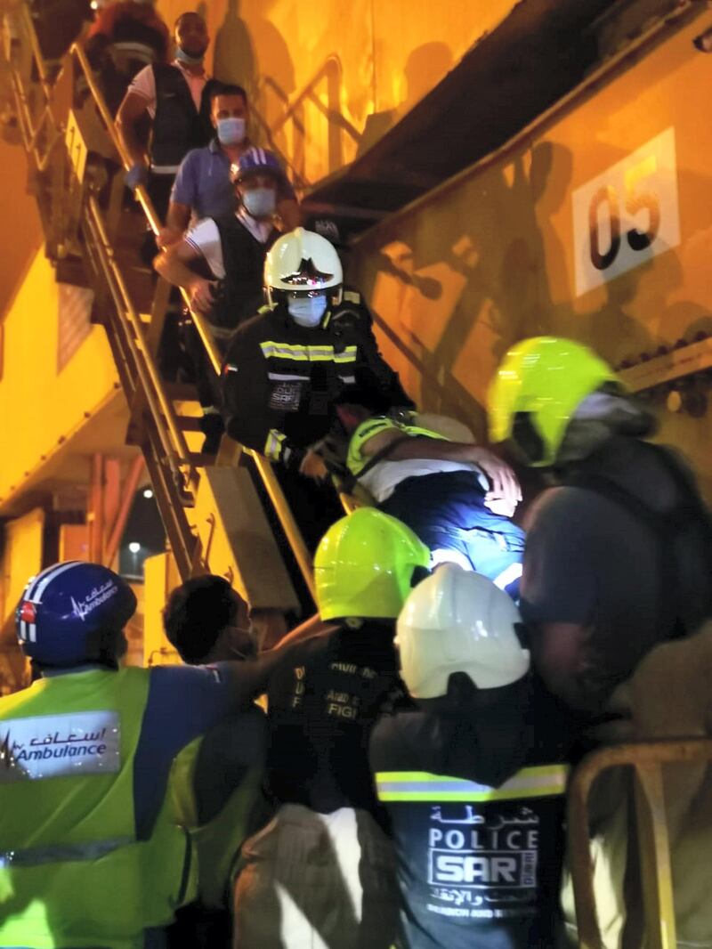 Police carry a crane operator down on a stretcher after he had a heart attack while working 65m above ground. Courtesy: Dubai Police