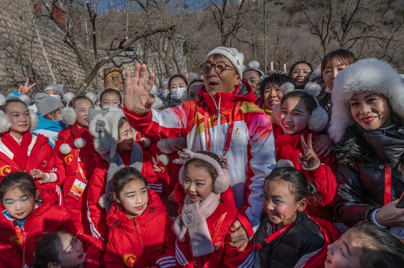 The 'Rush Hour' actor with school children and Olympic medallists on the torch relay. Getty Images