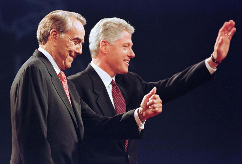 Dole and Bill Clinton wave to the audience after their first presidential debate in Hartford, Connecticut, in October 1996. Reuters