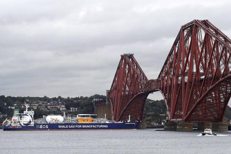 The tanker reverses under the Forth Bridge as it travels to dock at Grangemouth. Russell Cheyne / Reuters