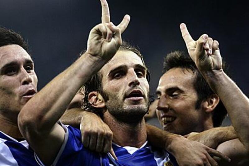 Ivan Alonso, the Espanyol captain, above centre, dedicates a goal against Malaga in September to Jarque, who wore the No 21 shirt.