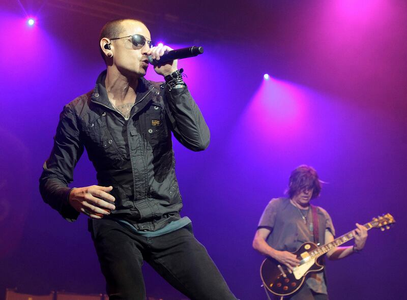 FILE - In this May 16, 2015, file photo, Chester Bennington, left, performs during the MMRBQ Music Festival 2015 at the Susquehanna Bank Center in Camden, N.J. Hundreds of Linkin Park fans gathered in downtown Los Angeles on Sunday, August 6, 2017, to pay tribute to late singer Chester Bennington nearly three weeks after his death. (Photo by Owen Sweeney/Invision/AP, File)