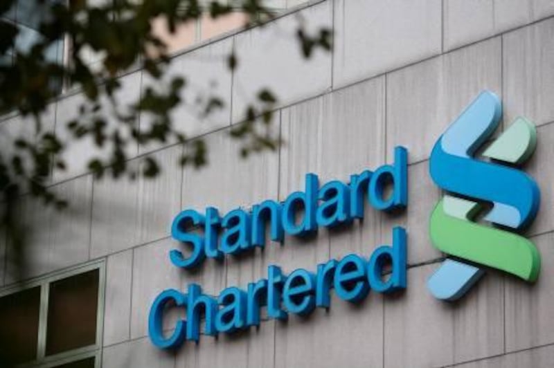 The Standard Chartered Plc logo is displayed at the Standard Chartered Bank Building in the central district of Hong Kong, China, on Saturday, March 2, 2013. Standard Chartered is scheduled to release annual results on March 5. Photographer: Jerome Favre/Bloomberg *** Local Caption ***  1175709.jpg