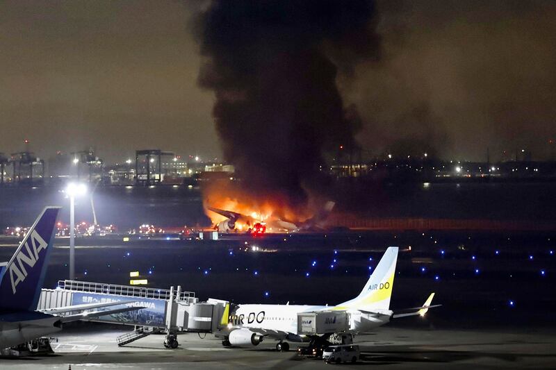 The Japan Airlines plane burns on the runway in Tokyo. AP