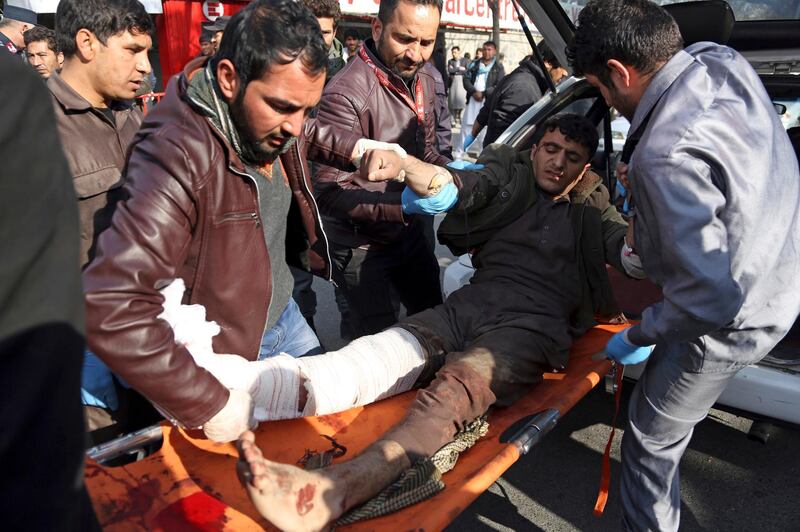 An injured man is moved to a stretcher outside a hospital following a suicide attack in Kabul, Afghanistan.  Rahmat Gul / AP Photo