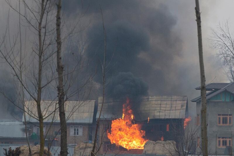 Flames and smoke billows from residential building where militants are suspected to have taken refuge during a gun battle in Pulwama, south of Srinagar, Indian controlled Kashmir, Monday, Feb. 18, 2019. Tensions continued to rise in the aftermath of a suicide attack in disputed Kashmir, with seven people killed Monday in a gunbattle that broke out as Indian soldiers scoured the area for militants. (AP Photo/ Dar Yasin)