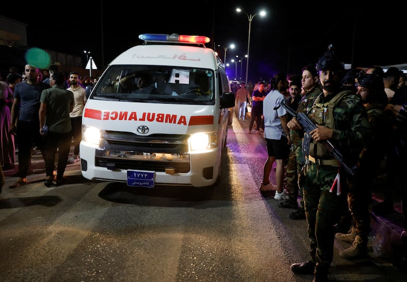 Security forces keep watch next to an ambulance. Reuters