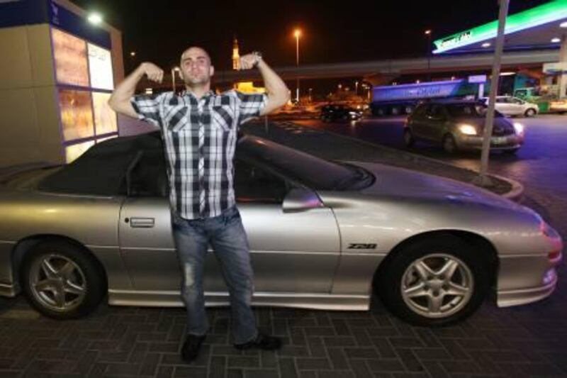 DUBAI - OCTOBER 11,2010 - Basil Yehia pose for a photoigraph beside his car at the parking lot in Dubai. ( Paulo Vecina/The National )