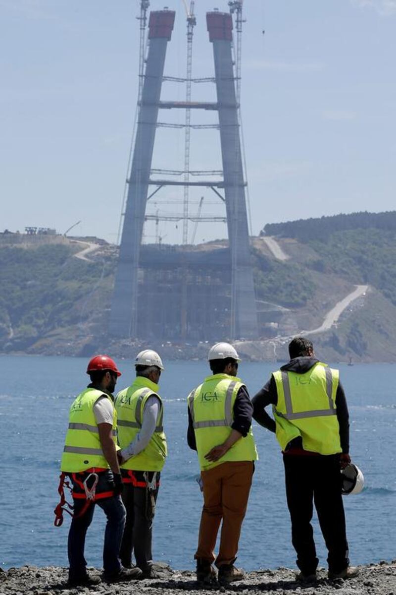 Workers overlook the construction site of the Yavuz Sultan Selim Bridge. Sedat Suna / EPA
