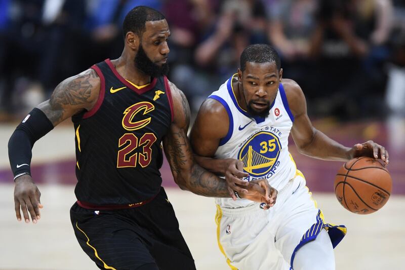 Golden State Warriors forward Kevin Durant drives against Cleveland Cavaliers forward LeBron James. Ken Blaze / Reuters