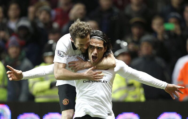 Manchester United’s Colombian striker Radamel Falcao, right, celebrates scoring the equalising goal with Manchester United’s Spanish midfielder Juan Mata during their match against Aston Villa at Villa Park in Birmingham, central England, on December 20, 2014. Adrian Dennis / AFP