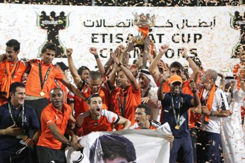 Dubai, United Arab Emirates, May 14, 2013 -    Ajman players celebrate with the trophy after winning against Jazira during the Pro League Etisalat Cup final at Al Wasl's Zabeel Stadium. ( Jaime Puebla / The National Newspaper ) 