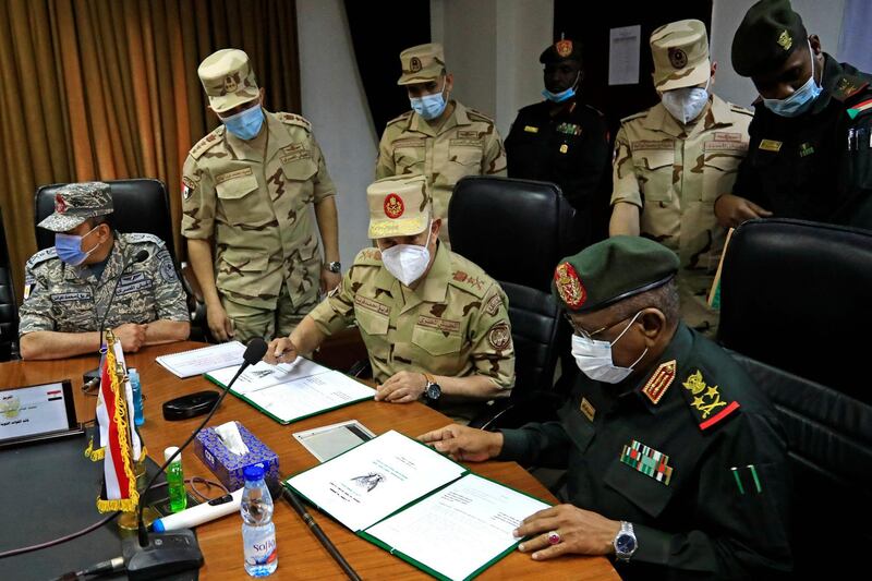 Egyptian military Chief of Staff Mohamed Farid and his Sudanese counterpart Mohamed Othman al-Hussein sign a bilateral agreement during a meeting of the Egyptian-Sudanese military committee in Sudan's capital Khartoum. AFP