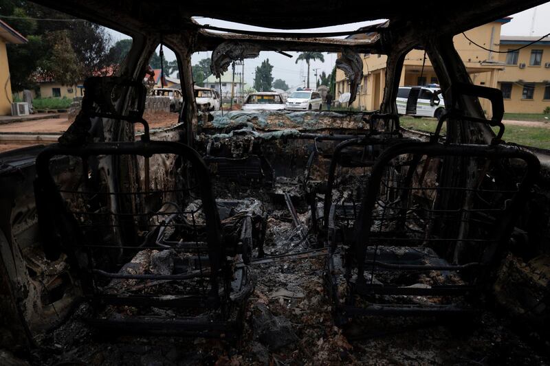 A burned vehicle is parked outside the police command headquarters in Owerri, Nigeria. Hundreds of inmates escaped from a prison in the southeastern Nigerian city after a series of coordinated attacks, according to government officials. AP Photo