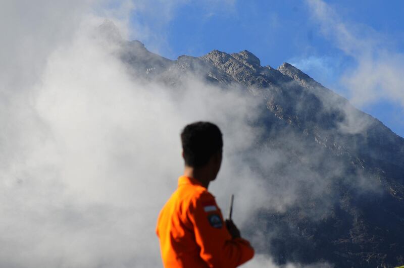 An officer from the National Search and Rescue Agency looks at Mount Merapi following a series of minor eruptions in Selo, Boyolali Regency, Central Java, Indonesia. Reuters