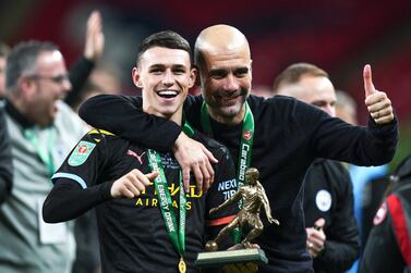 epa08263009 Phil Foden (L) of Manchester City celebrates with manager Pep Guardiola (R) after being named Man of the Match of the Carabao Cup final between Aston Villa and Manchester City at Wembley in London, Britain, 01 March 2020. EPA/WILL OLIVER EDITORIAL USE ONLY. No use with unauthorized audio, video, data, fixture lists, club/league logos or 'live' services. Online in-match use limited to 120 images, no video emulation. No use in betting, games or single club/league/player publications