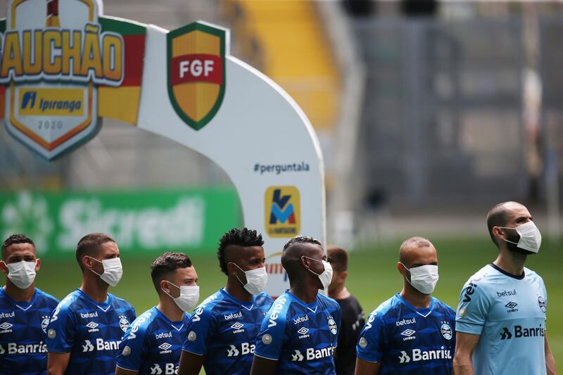 Gremio players line up with masks before the match against Sao Luiz in the Campeonato Gaucho in Brazil on Sunday, March 15. Reuters