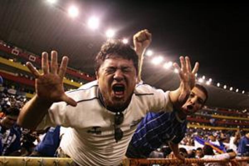 Honduran fans celebrate as their team win the game against El Salvador.