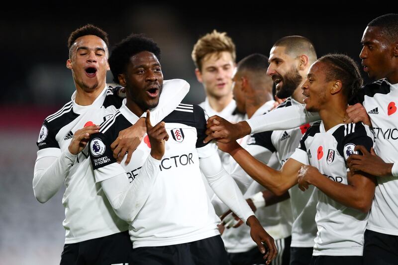 LONDON, ENGLAND - NOVEMBER 02: Ola Aina of Fulham celebrates with teammates after scoring his team's second goal  during the Premier League match between Fulham and West Bromwich Albion at Craven Cottage on November 02, 2020 in London, England. Sporting stadiums around the UK remain under strict restrictions due to the Coronavirus Pandemic as Government social distancing laws prohibit fans inside venues resulting in games being played behind closed doors. (Photo by Clive Rose/Getty Images)