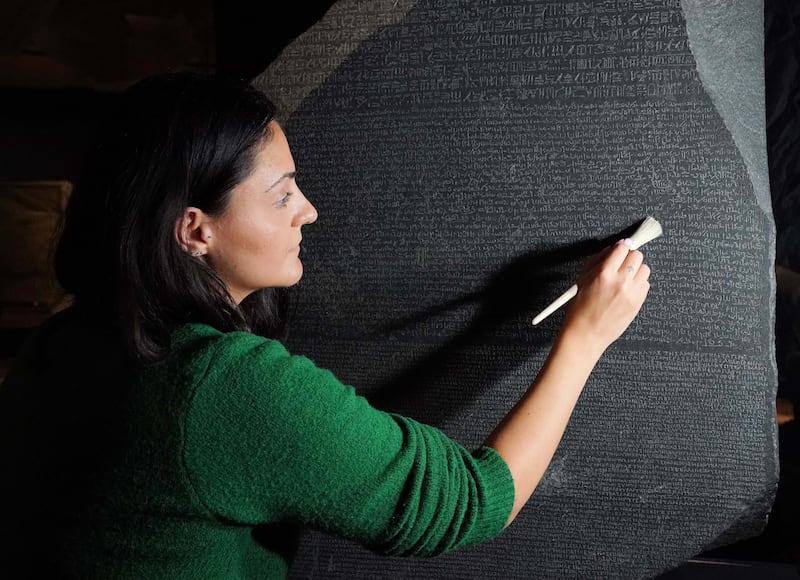 Senior conservator Stephanie Vasiliou prepares the Rosetta Stone before it is moved to a special exhibition in the British Museum to celebrate 200 years since it helped to decode hieroglyphs. PA