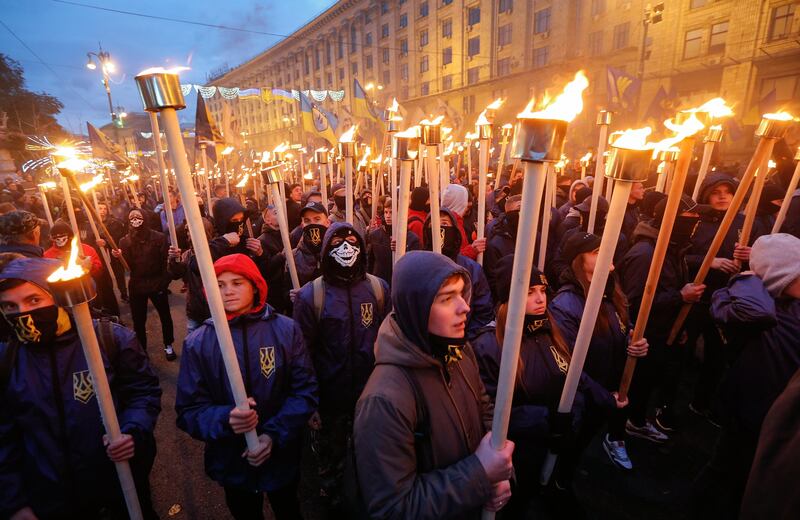 Activists and supporters of Ukrainian nationalist parties hold torches as the country celebrate the 75th anniversary of the creation of the Ukrainian Insurgent Army (UPA), in downtown Kiev, Ukraine. Sergey Dolzhenko / EPA