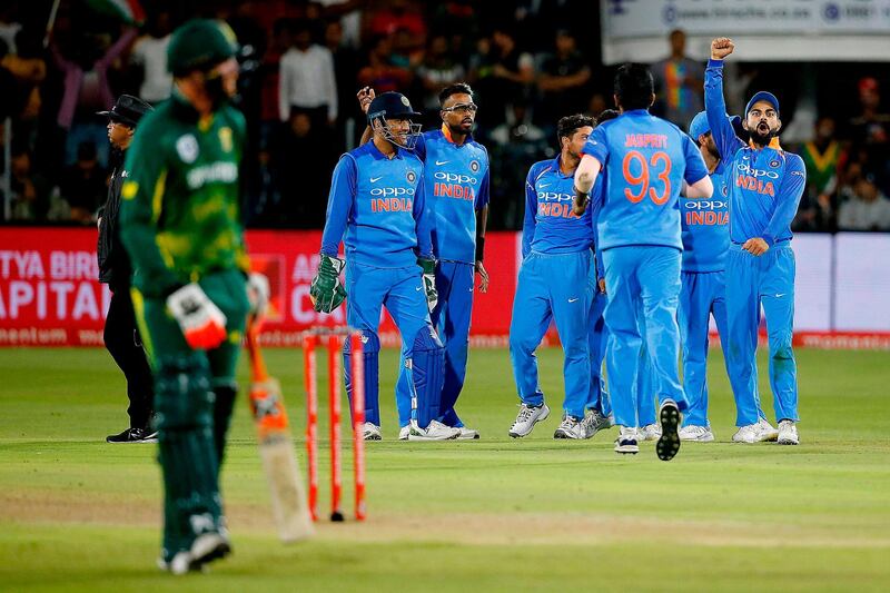 India's captain Virat Kohli (R) reacts after India's bowler Kuldeep Yadav bowled out South Africa's batsman Andile Phehlukwayo during the fifth one day international (ODI) cricket match between South Africa and India at St George Park in Port Elizabeth on February 13, 2018. / AFP PHOTO / MARCO LONGARI