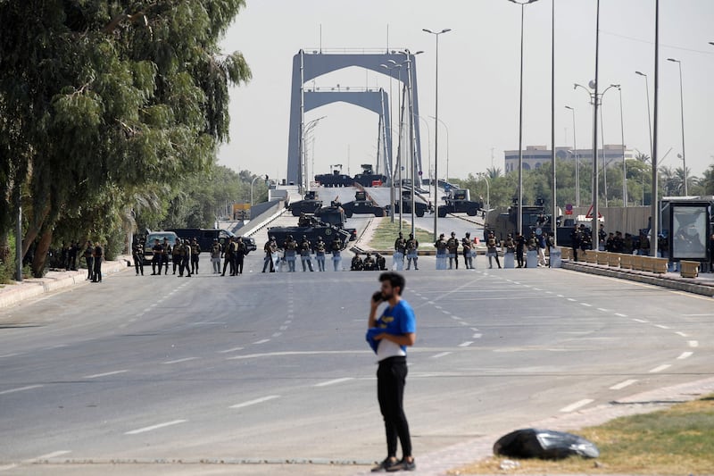 Iraqi police try to block the entrance to the Green Zone. AFP