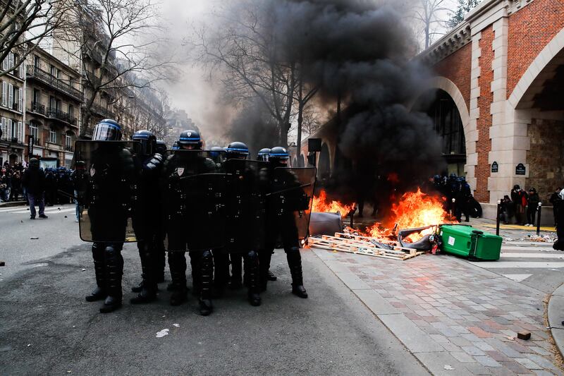 Police prepare to charge protesters during a demonstration day against the government's reform of the pension system in Paris.  EPA